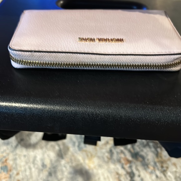 Michael Kohr, pink wristlet wallet with many different compartments inside